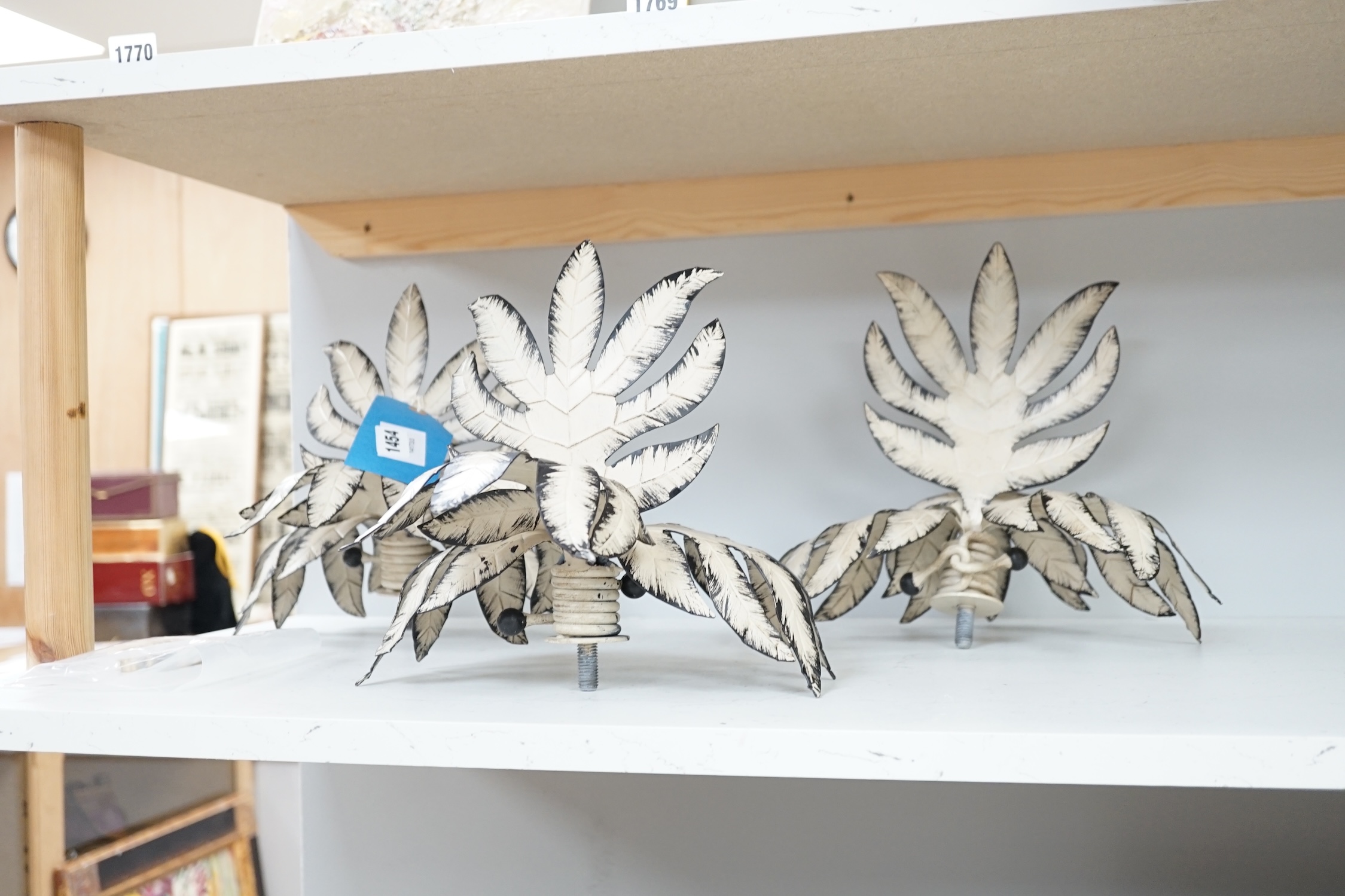 A set of four cream painted wrought iron leaf finials, approximately 26cm high, Condition - fair to good